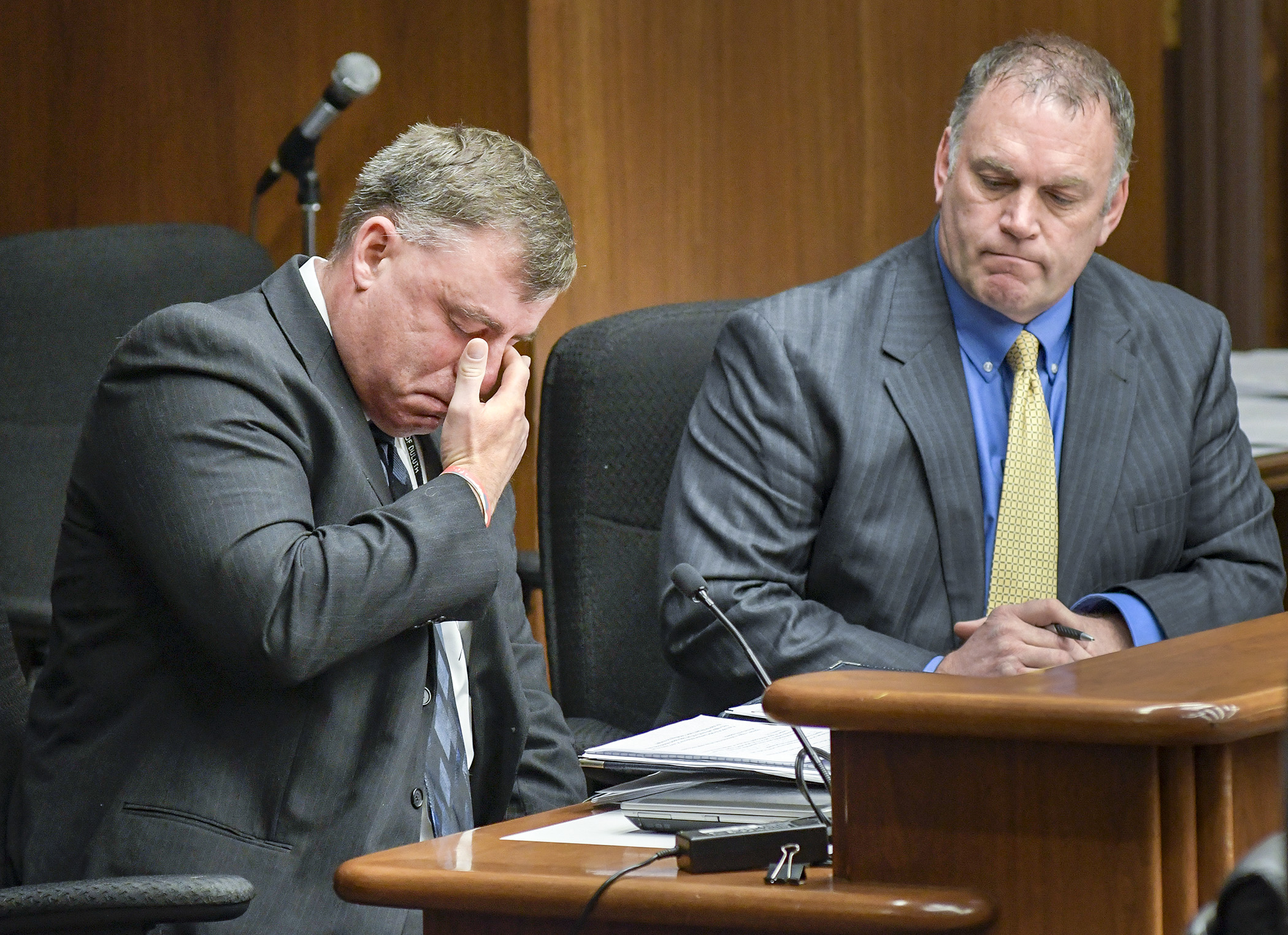 Duluth Police Department Lieutenant Jeff Kazel, left, pauses while relaying an emotional story to members of the House Health and Human Services Reform Committee March 1 during testimony on a bill sponsored by Rep. Dave Baker, right.